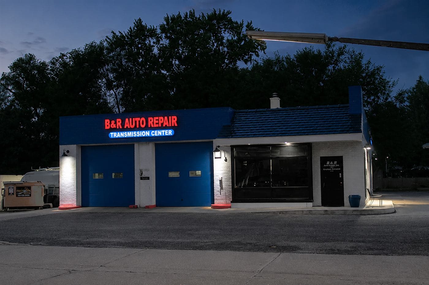 B&R Auto Repair storefront at dusk, red and blue signage lit